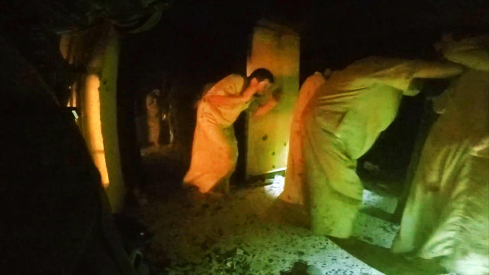 This image made from video taken on Thursday, Oct. 22, 2015 from a helmet camera, shows U.S. and Iraqi special forces freeing hostages from a prison controlled by Islamic State militants in the town of Huwija, 15 kilometers (9 miles) west of the Iraqi city of Kirkuk. The Kurdish regional government in northern Iraq released a video Sunday, Oct. 25, 2015 purportedly showing the joint raid of a prison by U.S. and Kurdish peshmerga forces in which they released 70 hostages from the Islamic State group's captivity. In the video, a line of panicked men in traditional ankle-length jalabiyas are seen running past the camera, some with their hands up, as Arabic-speaking men scream at them "let's go! Let's go!" They are marched through a dark room with the Islamic State group's trademark black flag draped over its wall. A U.S. Army Ranger will receive the Medal of Honor, the U.S. military’s highest honor for valor in combat, The Associated Press has learned. Sgt. Maj. Thomas Payne will receive the honor in a White House ceremony on the 19th anniversary of the September 11, 2001 terrorist attacks. (Kurdistan Regional Security Council via AP)