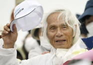 Japanese Kenichi Horie gets celebrated at a yacht harbor in Nishinomiya, western Japan, Sunday, June 5, 2022, after he completed his solo nonstop voyage across the Pacific Saturday. Horie’s return to Japan, after leaving San Francisco in March, made him the world’s oldest person to complete a solo, nonstop crossing of the Pacific, according to his sponsors. (Kosuke Moriwaki/Kyodo News via AP)
