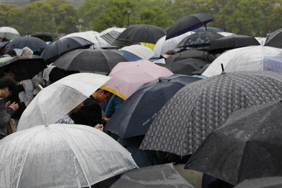 People gather near Imperial Palace in Tokyo Tuesday, April 30, 2019. Japan's Emperor Akihito announced that he is abdicating as of Tuesday at a ceremony, in his final official address to his people. (AP Photo/Eugene Hoshiko)