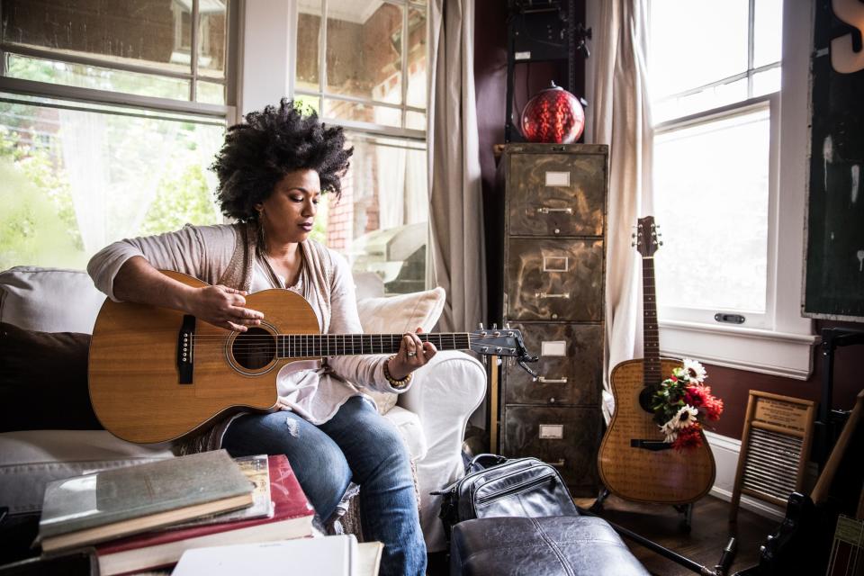 A woman playing a guitar