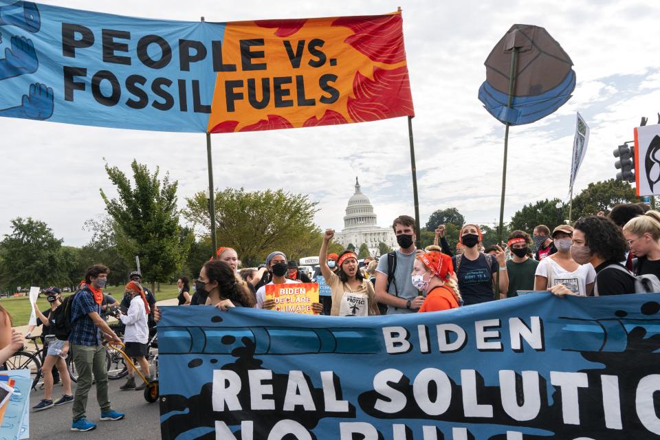 Climate and indigenous activists walk into the intersection of Pennsylvania and 3rd St NW during a climate change protest, Friday, Oct. 15, 2021, by the U.S. Capitol in Washington. (AP Photo/Jacquelyn Martin)