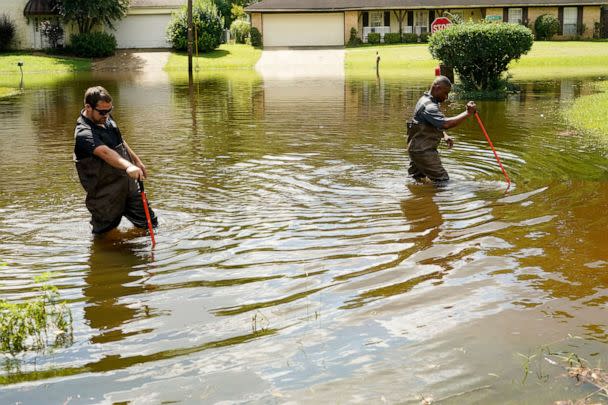 PHOTO: Hinds County Emergency Management Operations personnel wade through flood waters as they check water levels in neighborhoods that are near the Pearl River in northeast Jackson, Miss., Aug. 29, 2022.  (Rogelio V. Solis/AP)