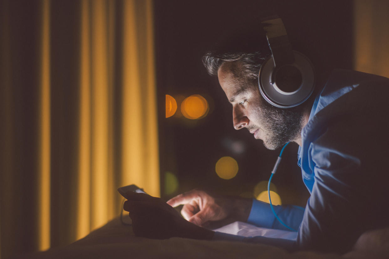 Man using tablet pc in evening.