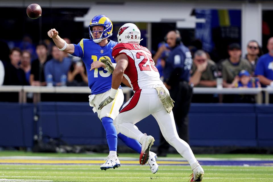 John Wolford #13 of the Los Angeles Rams passes under pressure from Zaven Collins #25 of the Arizona Cardinals in the first quarter of the game at SoFi Stadium on November 13, 2022, in Inglewood, California.