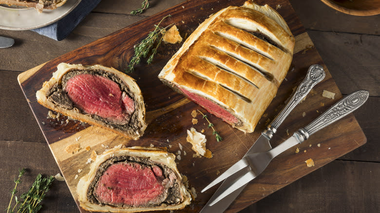 Sliced beef wellington on cutting board