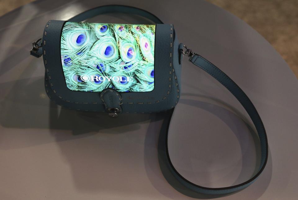 The prototype Royole FlexPai purse with a fully flexible display is shown off at CES International, Tuesday, Jan. 8, 2019, in Las Vegas. (AP Photo/Ross D. Franklin)