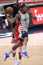 Washington Wizards guard Bradley Beal (3) looks to pass next to New Orleans Pelicans forward Naji Marshall, back, during the first half of an NBA basketball game Friday, April 16, 2021, in Washington. (AP Photo/Nick Wass)