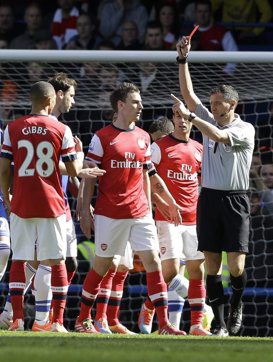 Arsenal's Kieran Gibbs, left, gets a red card during the English Premier League soccer match between Chelsea and Arsenal at Stamford Bridge stadium in London, Saturday, March 22, 2014. (AP Photo/Kirsty Wigglesworth)