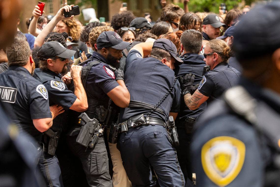 Pro-Palestinian demonstrators clash with police after replacing an American flag with a Palestinian flag Tuesday, April 30, 2024 at UNC-Chapel Hill. Police removed a “Gaza solidarity encampment” earlierTuesday morning.
