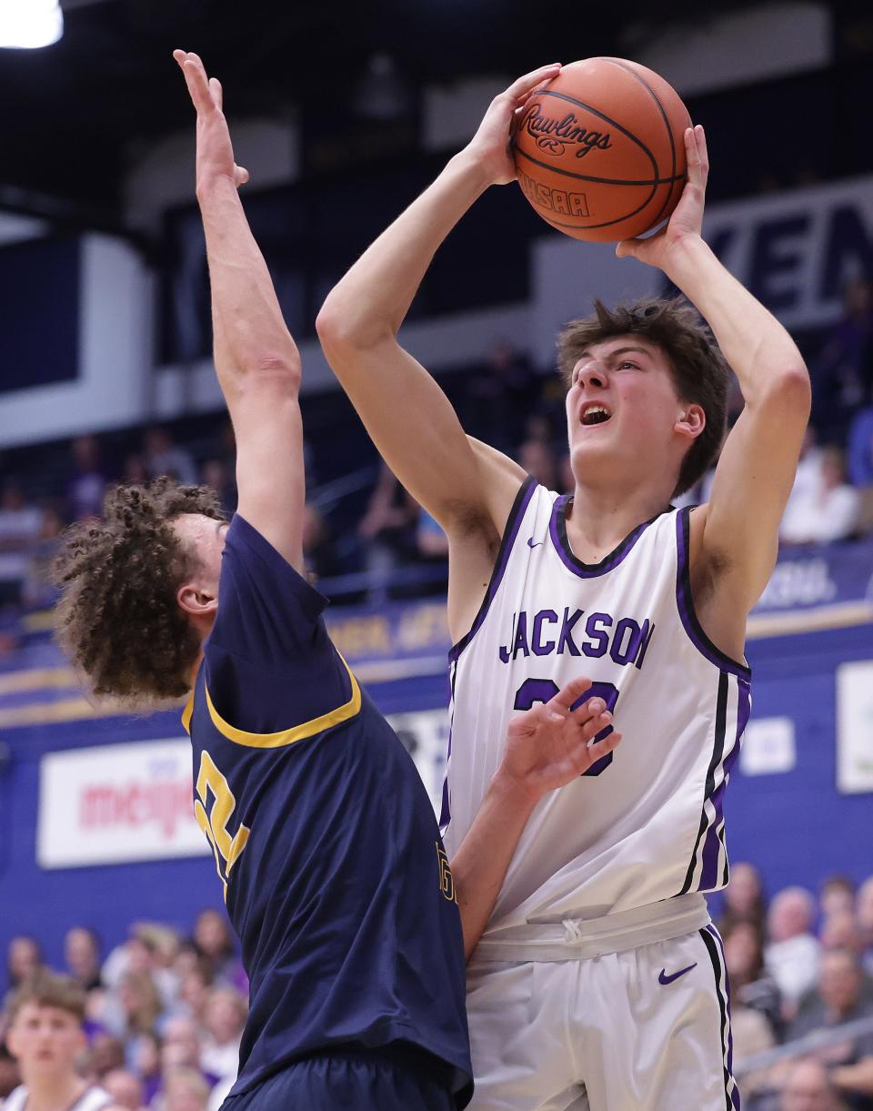 Jackson's Landon Thiel shoots over defense from St. Ignatius' Damon Friery in the second half during the OHSAA regional semifinal at Kent State, Wednesday, March 13, 2024.