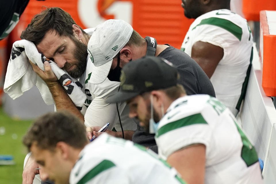 New York Jets quarterback Joe Flacco, top right, wipes sweat off his face during the second half of an NFL football game against the Los Angeles Chargers Sunday, Nov. 22, 2020, in Inglewood, Calif. (AP Photo/Jae C. Hong)