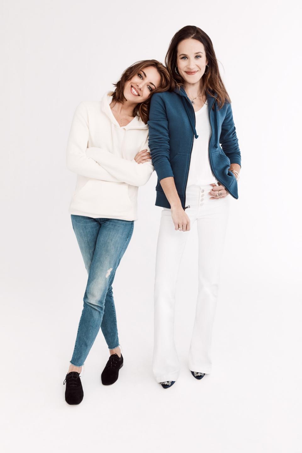 Actress Aubrey Plaza and Ashley Biden pose in hoodies from the new collection. (Photo: Gilt)