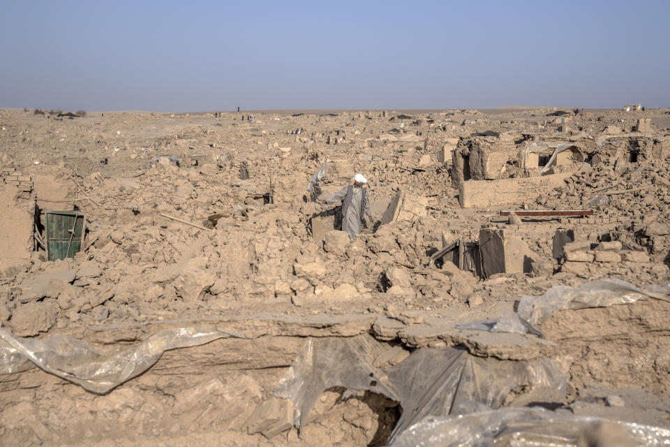 A man cleans up rubble after an earthquake in Zenda Jan district in Herat province, western Afghanistan, Wednesday, Oct. 11, 2023. Another strong earthquake shook western Afghanistan on Wednesday morning after an earlier one killed more than 2,000 people and flattened whole villages in Herat province in what was one of the most destructive quakes in the country's recent history. (AP Photo/Ebrahim Noroozi)