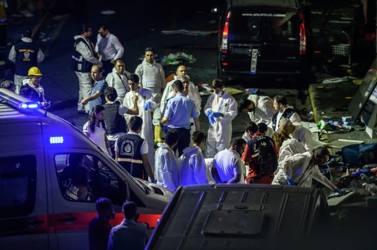 Forensic police work the explosion site at Ataturk airport on June 28, 2016 in Istanbul after two explosions followed by gunfire hit Turkey's biggest airport