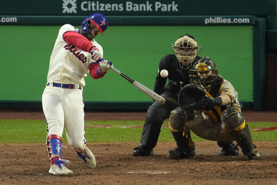 Philadelphia Phillies' Bryce Harper hits a two-run home run during the eighth inning in Game 5 of the baseball NL Championship Series between the San Diego Padres and the Philadelphia Phillies on Sunday, Oct. 23, 2022, in Philadelphia. (AP Photo/Matt Rourke)