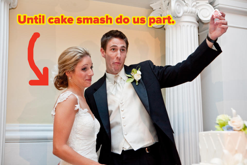 A bride and groom pose with the groom's hand poised to smash a piece of cake in the bride's grimacing face.