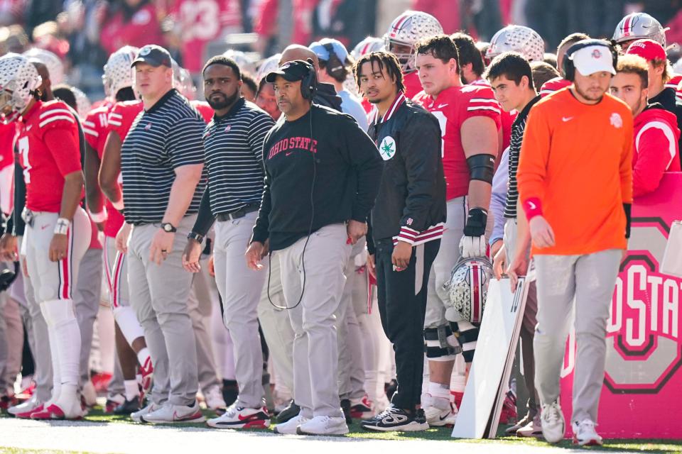 Ohio State receiver Jaxon Smith-Njigba watches from the sideline in street clothes during the game against Michigan.