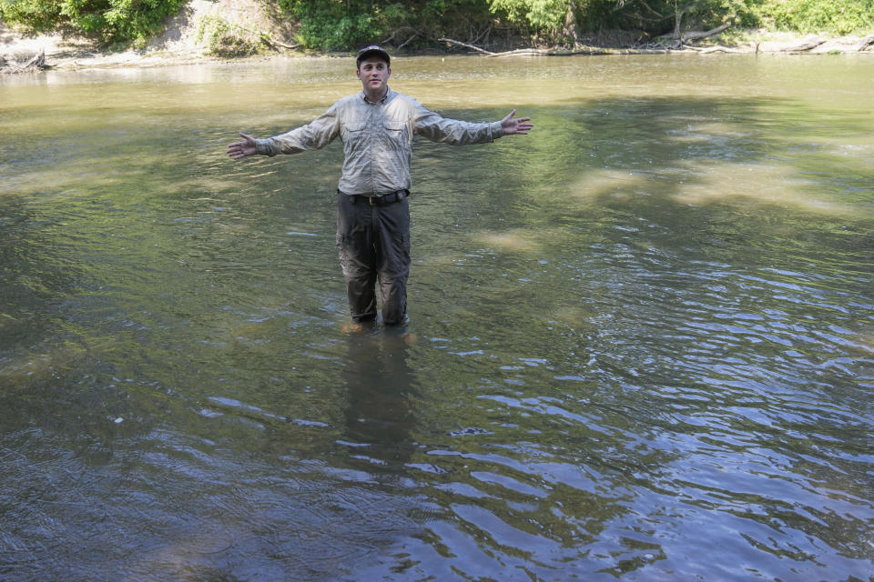 Matthew Wagner, a biologist from the U.S. Fish and Wildlife Service, gives a group announcement, as they release threatened pearl darter fish, which haven't lived in the Pearl River system for 50 years, in the Strong River, a tributary of the Pearl River, in Pinola, Miss., Monday, July 31, 2023. Wildlife experts say a number of pollution and habitat problems likely contributed to the disappearance of the pearl darter from the Pearl River system. (AP Photo/Gerald Herbert)