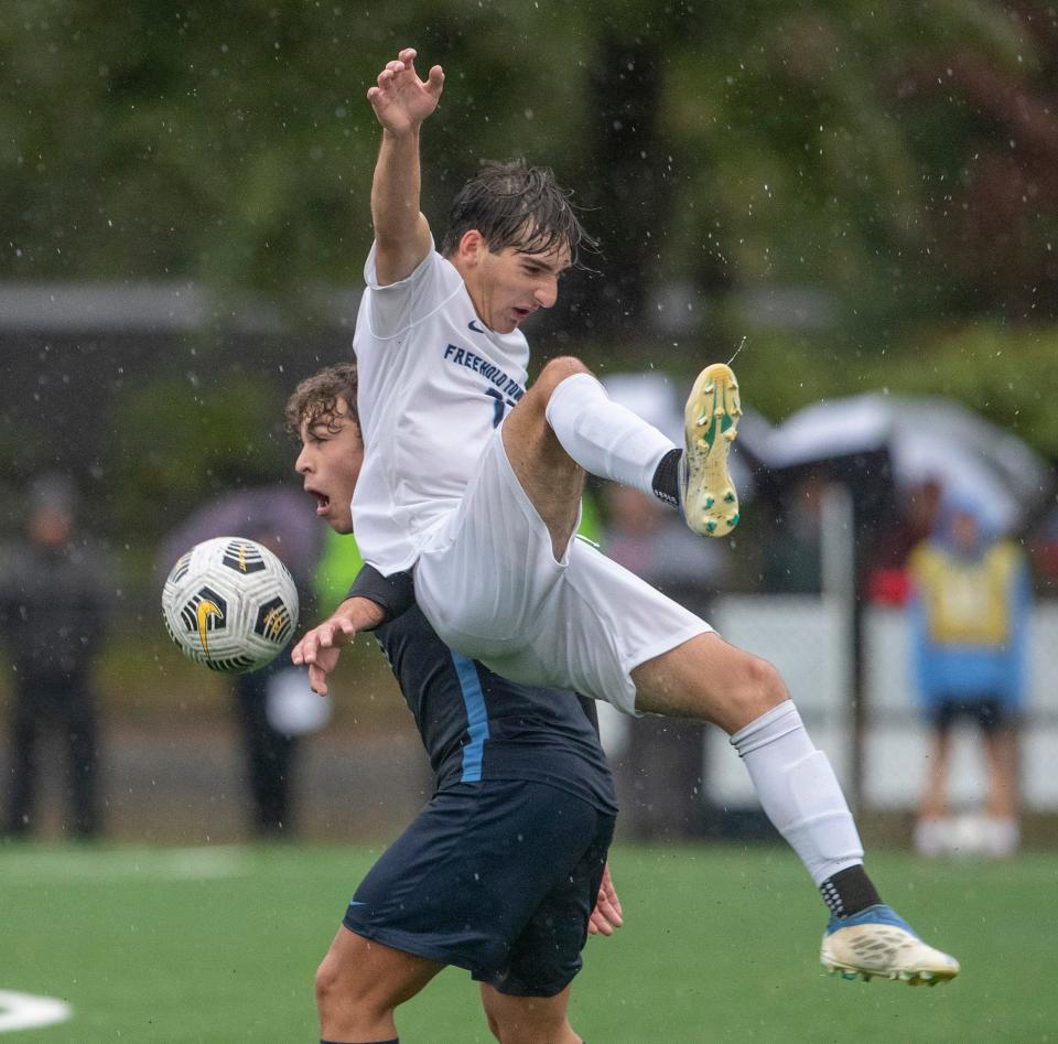 Freehold Alesandro Principato slides down the back of  CBA Dimitry Corba. Christian Brothers Academy  Soccer defeats Freehold Township 1-0 in OT in Middletown, NJ on October 3, 2022. 