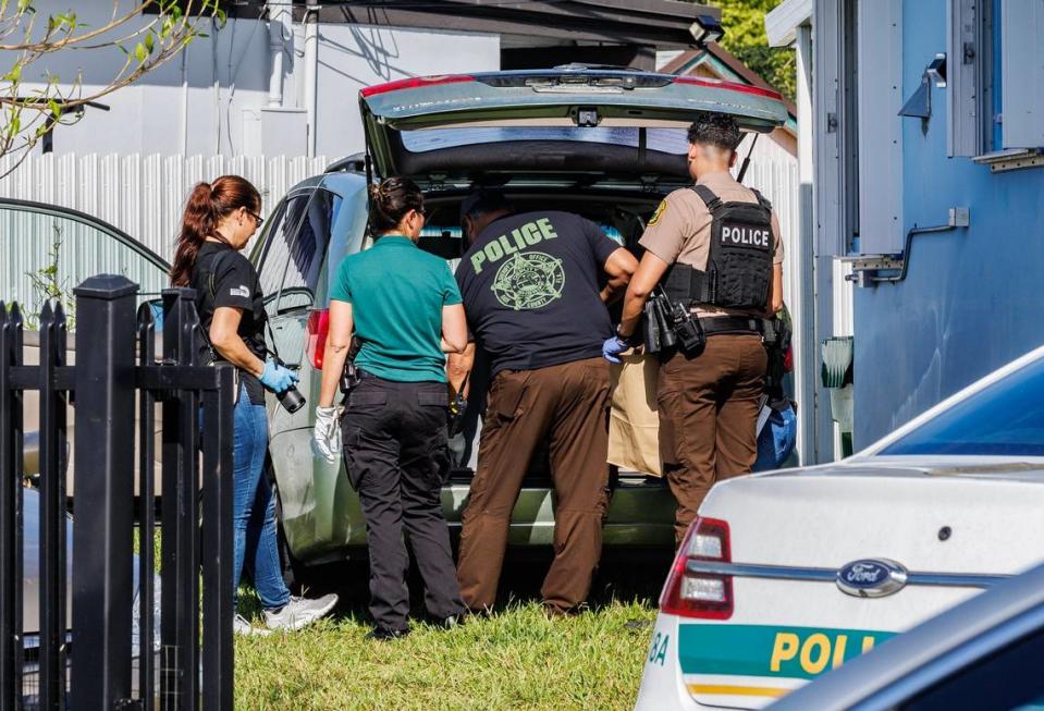Miami-Dade Police look through a minivan parked at a home located at 11901 SW 185th Terrace on Saturday, Jan. 27, 2024. Police say an unlicensed veterinary clinic was operating out of the home.