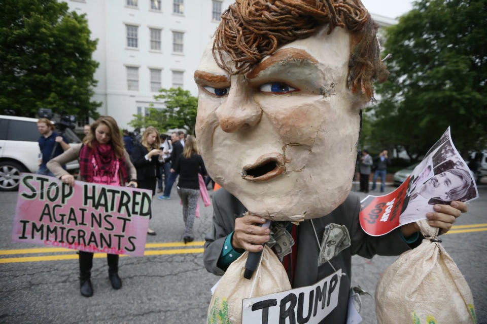 A masked protester demonstrates outside Republican National Committee (RNC) headquarters, where Republican U.S. presidential candidate Donald Trump was meeting with House Speaker Paul Ryan (R-Wis.) and RNC Chairman Reince Priebus in Washington, May 12, 2016. (Jim Bourg/Reuters)