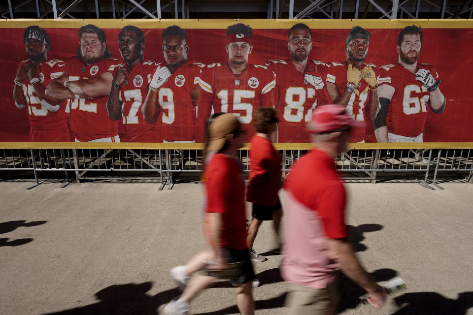 Kansas City Chiefs fans walk past signage as they arrive at NFL football training camp Saturday, July 30, 2022, in St. Joseph, Mo. (AP Photo/Charlie Riedel)