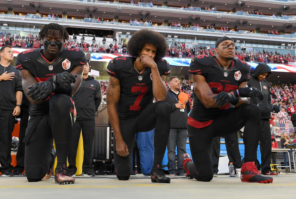 Teammates Eli Harold, Kaepernick and Eric Reid kneel in protest during the national anthem prior to a game against the Arizona Cardinals on Oct. 6, 2016. (Photo: Thearon W. Henderson via Getty Images)