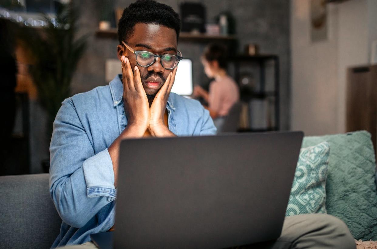 Disinformation campaigns use emotional and rhetorical tricks to try to get you to share propaganda and falsehoods. <a href="https://www.gettyimages.com/detail/photo/worried-man-working-at-home-looking-in-laptop-royalty-free-image/1451439821" rel="nofollow noopener" target="_blank" data-ylk="slk:hobo_018/E+ via Getty Images;elm:context_link;itc:0;sec:content-canvas" class="link ">hobo_018/E+ via Getty Images</a>