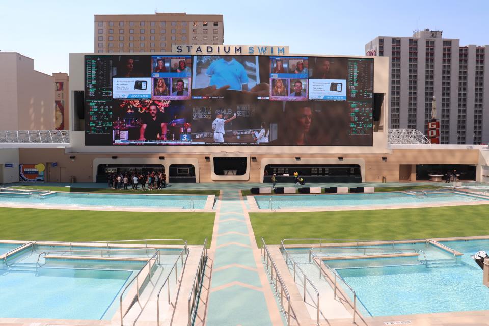 Stadium Swim has a giant 135-foot screen for pool-goers.