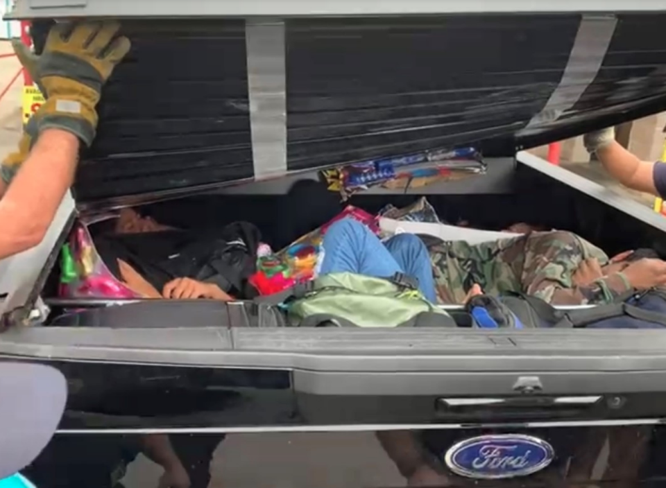 Migrants trapped inside the bed cover of a pickup truck. / Credit: U.S. Department of Justice