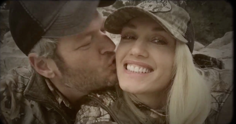 Blake Shelton kissing Gwen Stefani on her cheek. 