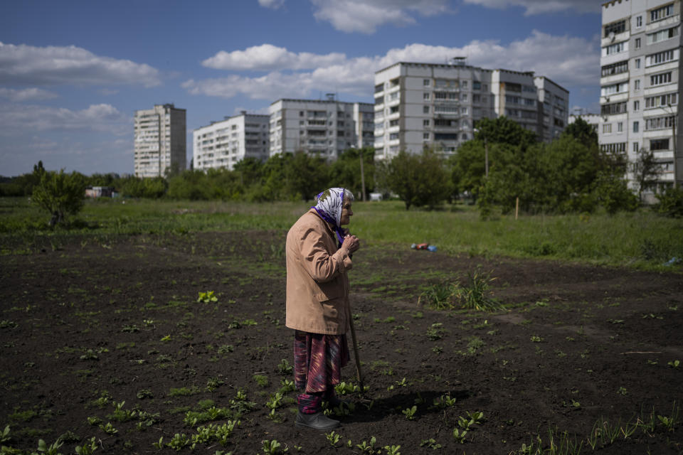 Lyudmila, 85, tends to the garden in Kharkiv, eastern Ukraine, Monday, May 23, 2022. (AP Photo/Bernat Armangue)