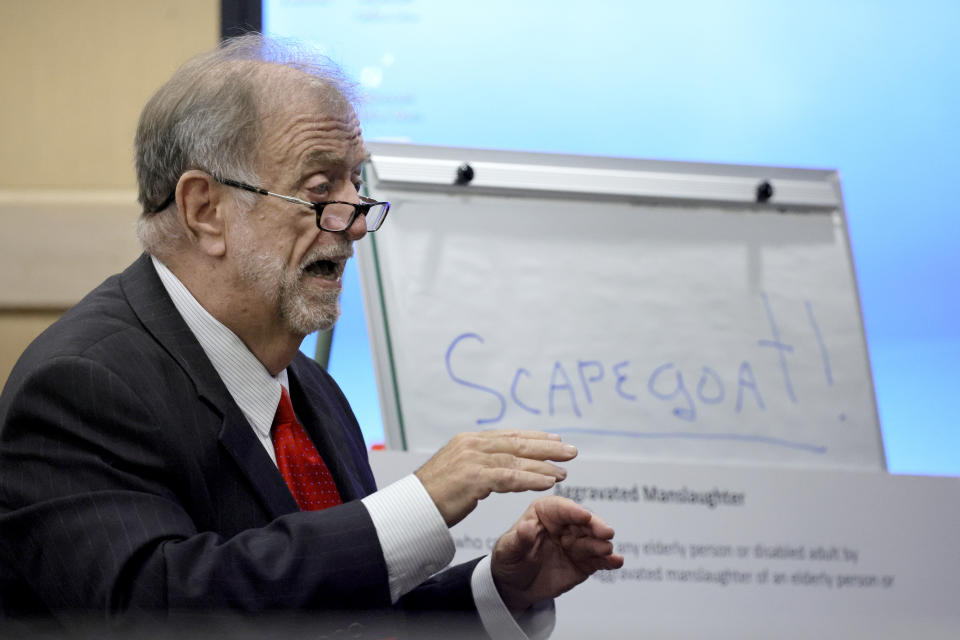 Defense attorney James Cobb gives his opening statement after writing "Scapegoat!" on a presentation board during Jorge Carballo's Rehabilitation Center at Hollywood Hills manslaughter case at the Broward County Courthouse in Fort Lauderdale, Fla., Monday, Feb. 6, 2023. A dozen elderly patients at the Hollywood Hills nursing home died from sweltering conditions after Hurricane Irma in 2017. (Amy Beth Bennett/South Florida Sun-Sentinel via AP, Pool)