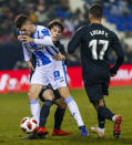 Real Madrid's Odriozola, center, duels for the ball with Leganes' Gumbau during a Spanish Copa del Rey soccer match between Leganes and Real Madrid at the Butarque stadium in Leganes, Spain, Wednesday, Jan. 16, 2019. (AP Photo/Valentina Angela)