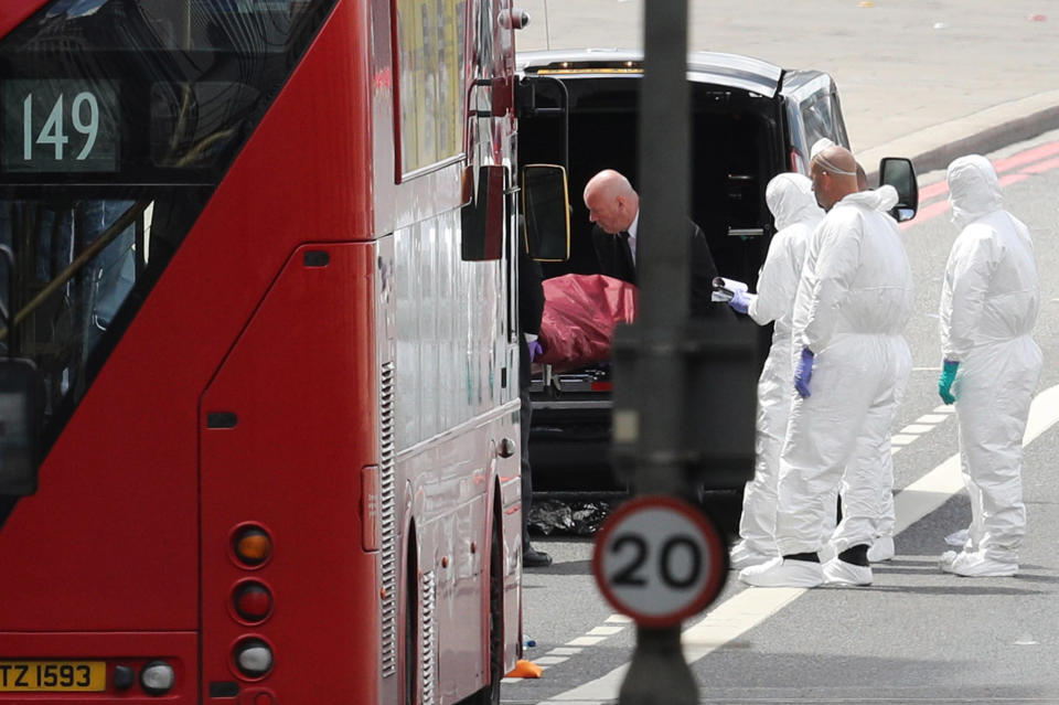 Forensic officers move a stretcher into the back of an ambulance on London Bridge.&nbsp;
