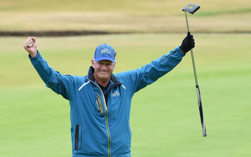 Scotland's Sandy Lyle celebrates making a birdie putt on the 18th green - AFP