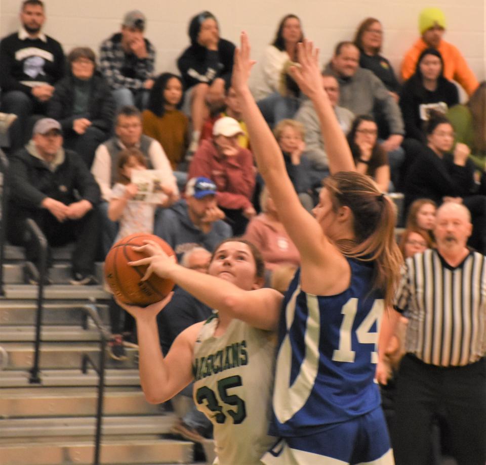 Herkimer Magician Bailey Bray works her way around Dolgeville defender Payton Comstock (14) and prepares to shoot during a Section III quarterfinal played Tuesday in Herkimer.