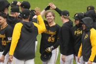 Pittsburgh Pirates' Jack Suwinski (65) celebrates with teammates after driving in the winning run with a walkoff single off Colorado Rockies relief pitcher Nick Mears during the ninth inning of a baseball game in Pittsburgh, Saturday, May 4, 2024. (AP Photo/Gene J. Puskar)
