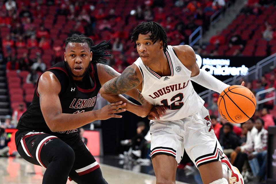 Louisville forward JJ Traynor (12) attempts to drive past the defense of Lenoir-Rhyne forward Tim Steele (11) during the first half of their exhibition game, Sunday, Oct. 30 2022 in Louisville Ky.