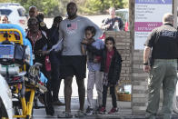 A family departs the reunification center at the Woodmont Baptist church after a school shooting, Monday, March 27, 2023, in Nashville, Tenn. (AP Photo/John Bazemore)