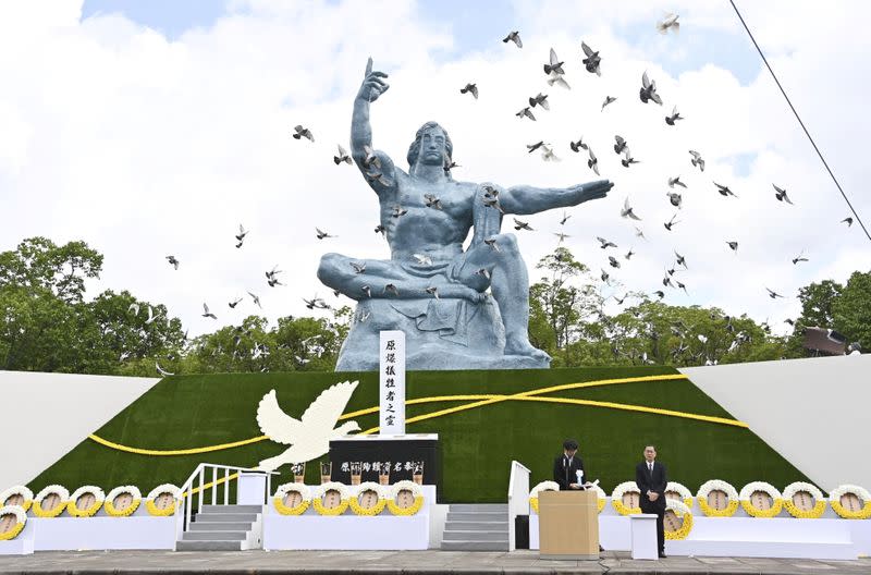 Doves fly over the Peace Statue in Nagasaki's Peace Park during a ceremony commemorating the 75th anniversary of the bombing of the city, in Nagasaki