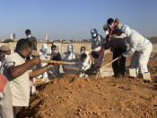 Victims of the flash flood are buried in Derna, Libya, Friday, Sept. 15, 2023. The death toll in Libya's coastal city of Derna has soared to over ten thousand as search efforts continue following a massive flood fed by the breaching of two dams in heavy rains, the Libyan Red Crescent said Thursday. (AP Photo/Yousef Murad)