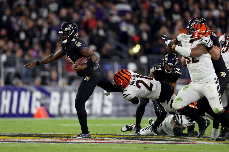 BALTIMORE, MARYLAND – NOVEMBER 16: <a class="link " href="https://sports.yahoo.com/nfl/players/29510" data-i13n="sec:content-canvas;subsec:anchor_text;elm:context_link" data-ylk="slk:Mike Hilton;sec:content-canvas;subsec:anchor_text;elm:context_link;itc:0">Mike Hilton</a> #21 of the Cincinnati Bengals tackles Lamar Jackson #8 of the Baltimore Ravens during the second quarter of the game at M&T Bank Stadium on November 16, 2023 in Baltimore, Maryland. (Photo by Patrick Smith/Getty Images)