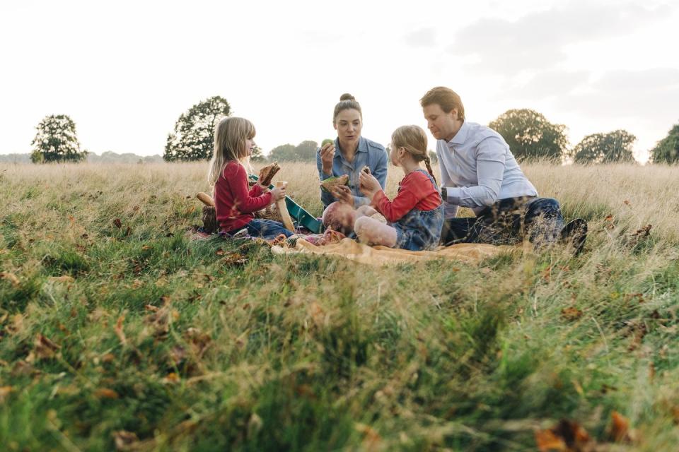 a group of people sitting in a field