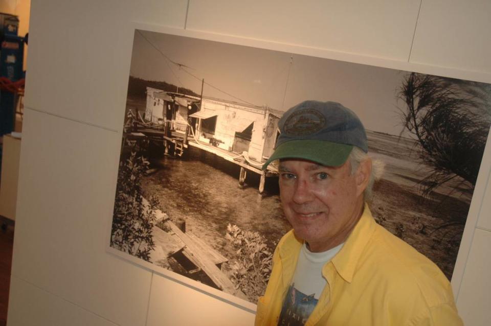 In this file photo from Oct. 30, 2007, author and photographer Tom Corcoran is pictured in front of one of his 70 photographs of Key West that were on exhibit at the historic Custom House in the Southernmost City. Cammy Clark/Miami Herald file