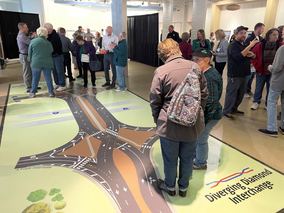 People standing on an example of a diverging diamond interchange during an open house to explain the new interchange construction coming to 41st Street and I-29.