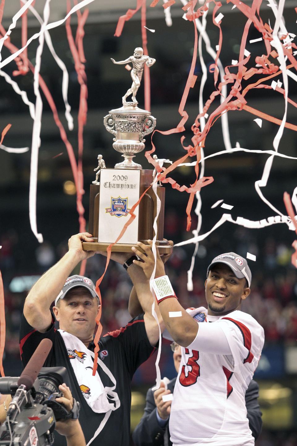 Utah coach Kyle Wittingham and quarterback Brian Johnson hold up the Sugar Bowl championship trophy after an NCAA football game in the Sugar Bowl in New Orleans, Friday, Jan. 2, 2009. Utah defeated Alabama 31-17. | Dave Martin, Associated Press