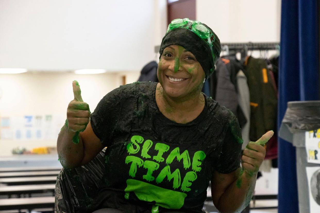 Alliance Intermediate School Assistant Superintendent Erica Jackson gives the "Slime Time" event a thumbs up while covered with the goopy mess. Students at the school purchased raffle tickets for the chance pour slime over the school's staff.