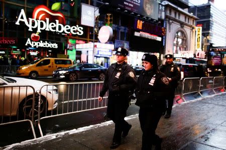 New York Police Department (NYPD) officers walk around Times Square ahead of New Year's Eve celebrations in Manhattan, New York, U.S. December 30, 2017. REUTERS/Eduardo Munoz