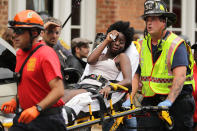 <p>Rescue workers move victims on stretchers after car plowed through a crowd of counter-demonstrators marching through the downtown shopping district Aug. 12, 2017 in Charlottesville, Va. (Photo: Chip Somodevilla/Getty Images) </p>